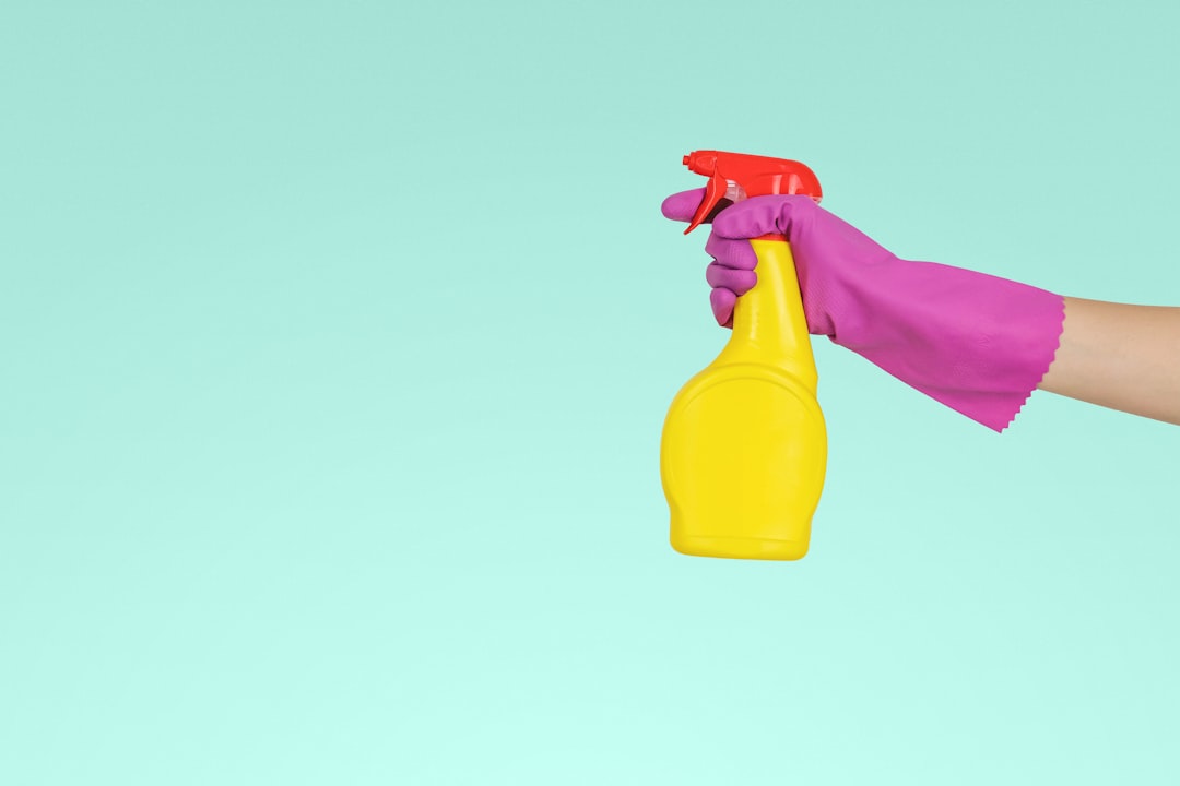 about-us person-holding-yellow-plastic-spray-bottle-zmnefoi3k